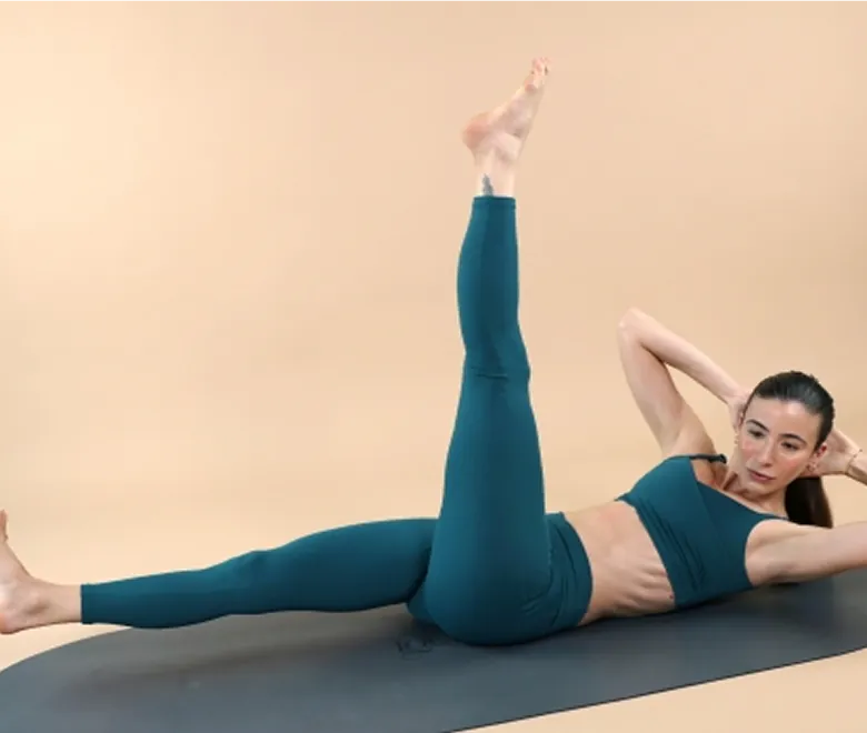 Woman performing a Pilates exercise for body reshaping