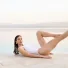 Carlotta Gagna performing a reclining Pilates pose beside an infinity pool with one leg extended and the other bent in Pilates Linfodrenante®