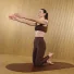 Carlotta Gagna kneeling on a mat with both arms extended forward and one foot lifted behind her in Pilates Linfodrenante®